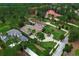 Aerial view showcases a large home with a pool, circular driveway, and greenery at 16828 Vinci Way, Montverde, FL 34756