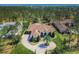 Expansive aerial view of a luxurious estate with sprawling grounds and a meticulously designed circular driveway at 16828 Vinci Way, Montverde, FL 34756