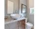 Stylish powder room features a vessel sink, granite countertop, and framed mirror at 16828 Vinci Way, Montverde, FL 34756
