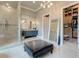 Neutral-toned bathroom with glass shower, large vanity, and an entrance to a walk-in closet at 16828 Vinci Way, Montverde, FL 34756