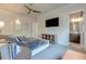Comfortable bedroom with a ceiling fan, TV, ensuite bathroom, and neutral tones for a relaxing atmosphere at 16828 Vinci Way, Montverde, FL 34756