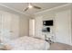 Bedroom includes a desk, TV, and closet space, offering comfort and functionality in a modern design at 16828 Vinci Way, Montverde, FL 34756