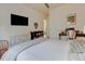 Bright bedroom features a TV, modern decor, and a study desk, offering a comfortable living space at 16828 Vinci Way, Montverde, FL 34756