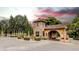 Elegant stone gatehouse entrance with a beautiful fountain and mature landscaping at 16828 Vinci Way, Montverde, FL 34756