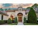 Stunning curb appeal with a tile roof and arched entryway at 16828 Vinci Way, Montverde, FL 34756