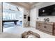 Stylish game room with a pool table visible through the doorway, modern decor, and a mounted TV at 16828 Vinci Way, Montverde, FL 34756