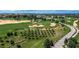 Beautiful aerial view of a golf course with lush green fairways, sand traps and mature trees at 16828 Vinci Way, Montverde, FL 34756