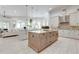 Open concept kitchen with large island, stainless appliances, and ample cabinet space at 16828 Vinci Way, Montverde, FL 34756