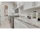 Bright laundry room with granite countertops and ample storage at 16828 Vinci Way, Montverde, FL 34756