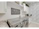 Well-appointed laundry room with modern washer and dryer, storage cabinets, and granite countertops at 16828 Vinci Way, Montverde, FL 34756