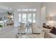 Bright and airy living room with a view to the outside, stylish seating, and tile flooring at 16828 Vinci Way, Montverde, FL 34756