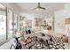 Open floorplan living room showcases a sleek white sofa, geometric rug, and a glimpse of the kitchen at 16828 Vinci Way, Montverde, FL 34756