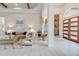 Bright living room with high ceilings, wood beams, and a decorative chandelier over a tile floor at 16828 Vinci Way, Montverde, FL 34756
