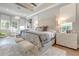 Bright main bedroom featuring tray ceilings, wood floors, and luxurious modern decor at 16828 Vinci Way, Montverde, FL 34756