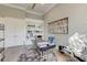 Bright home office with custom built-ins, modern desk, decor, and light hardwood flooring at 16828 Vinci Way, Montverde, FL 34756