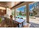Large outdoor dining table with views of the pool, landscaping, and nearby guest house at 16828 Vinci Way, Montverde, FL 34756