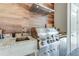 Stainless steel outdoor grill with wood-look backsplash and mini fridge at 16828 Vinci Way, Montverde, FL 34756