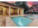 Heated backyard pool and patio with a covered dining area at 16828 Vinci Way, Montverde, FL 34756