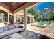 Beautiful outdoor area with a large pool, spa, hammock, and outdoor living space at 16828 Vinci Way, Montverde, FL 34756