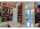 Spacious walk-in closet with custom shelving for shoes and a view into the luxury bathroom at 16828 Vinci Way, Montverde, FL 34756