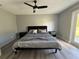 Spacious bedroom with gray walls and wood-look floors, and sliding glass door access to backyard at 17 S Flag Ct, Kissimmee, FL 34759