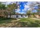 Exterior view of the back of the house with a patio and a partially fenced-in yard at 220 Lake Gene Dr, Longwood, FL 32779