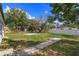 Lush backyard with mature trees, patio space, and privacy fence at 220 Lake Gene Dr, Longwood, FL 32779