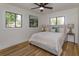 Serene bedroom featuring warm hardwood floors, an abundance of natural light, and neutral decor at 220 Lake Gene Dr, Longwood, FL 32779