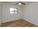 Bright bedroom features light wood flooring, a ceiling fan, and a window for natural light at 220 Lake Gene Dr, Longwood, FL 32779