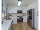 Modern kitchen featuring white cabinetry, quartz countertops, stainless steel appliances and lots of natural light at 220 Lake Gene Dr, Longwood, FL 32779