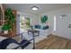 Cozy living room featuring natural light, neutral-colored decor, wood-look flooring, and a brick accent wall at 220 Lake Gene Dr, Longwood, FL 32779