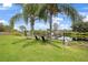 Serene backyard oasis with lake view, lush lawn, and relaxing chairs at 1053 Abadan Dr, Deltona, FL 32725