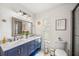 Elegant bathroom with dual sinks and navy blue vanity at 1053 Abadan Dr, Deltona, FL 32725