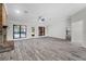 Large living room with view of the brick fireplace and screened in porch at 157 Ambergate Ct, Debary, FL 32713