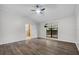 Main bedroom with wood flooring, neutral color palette, fan and view to ensuite bathroom at 157 Ambergate Ct, Debary, FL 32713