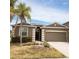 Charming single-story home featuring desert landscaping, a two-car garage, and a welcoming front entrance at 2652 Carrickton Cir, Orlando, FL 32824