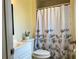 Cozy bathroom with a toilet, tub and shower combo, and white floral shower curtain at 3804 Janie Ct, Orlando, FL 32822