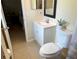 Bright bathroom featuring a modern vanity, neutral tile flooring, and decorative floral arrangement at 3804 Janie Ct, Orlando, FL 32822