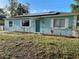 Charming blue home featuring a well-manicured lawn, solar panels, and classic white shutters at 3804 Janie Ct, Orlando, FL 32822