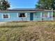 Charming single-story home with blue exterior, white trim, solar panels, and front yard at 3804 Janie Ct, Orlando, FL 32822