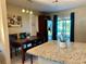 Eat-in kitchen with stainless steel appliances, granite counters, and backyard access at 3804 Janie Ct, Orlando, FL 32822