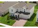 Aerial view of a beautiful, two-story home with a brick-paved driveway and well-maintained landscaping at 463 Shadow Gorge Way, Eustis, FL 32736
