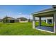 Spacious backyard with a covered patio, perfect for outdoor entertaining and relaxation on a sunny day at 463 Shadow Gorge Way, Eustis, FL 32736