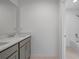 Elegant bathroom boasts double vanity with stone countertop and modern fixtures at 463 Shadow Gorge Way, Eustis, FL 32736