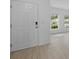 Bright entryway with light tile flooring, a white front door, and large windows offering pleasant views at 463 Shadow Gorge Way, Eustis, FL 32736