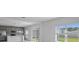 Bright, open-plan living area with access to kitchen and sliding glass doors that fill room with natural light at 463 Shadow Gorge Way, Eustis, FL 32736