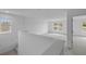 Bright, open loft area with natural light from two windows and neutral carpeting at 463 Shadow Gorge Way, Eustis, FL 32736