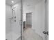 Modern glass-enclosed shower with chrome fixtures and convenient access to walk-in closet at 463 Shadow Gorge Way, Eustis, FL 32736