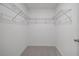 Spacious walk-in closet features overhead shelving for optimal storage and organization at 463 Shadow Gorge Way, Eustis, FL 32736