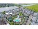 Aerial view showcasing the apartment buildings, pool, garages, and surrounding landscapes at 7573 Laureate Blvd # 1301, Orlando, FL 32827